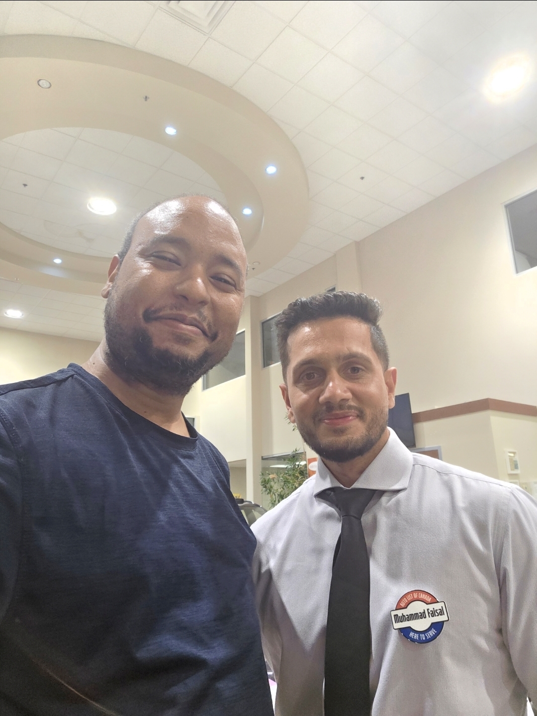 Dr. Ahmed with Muhammad Faisal at the Auto List of Canada showroom in Winnipeg